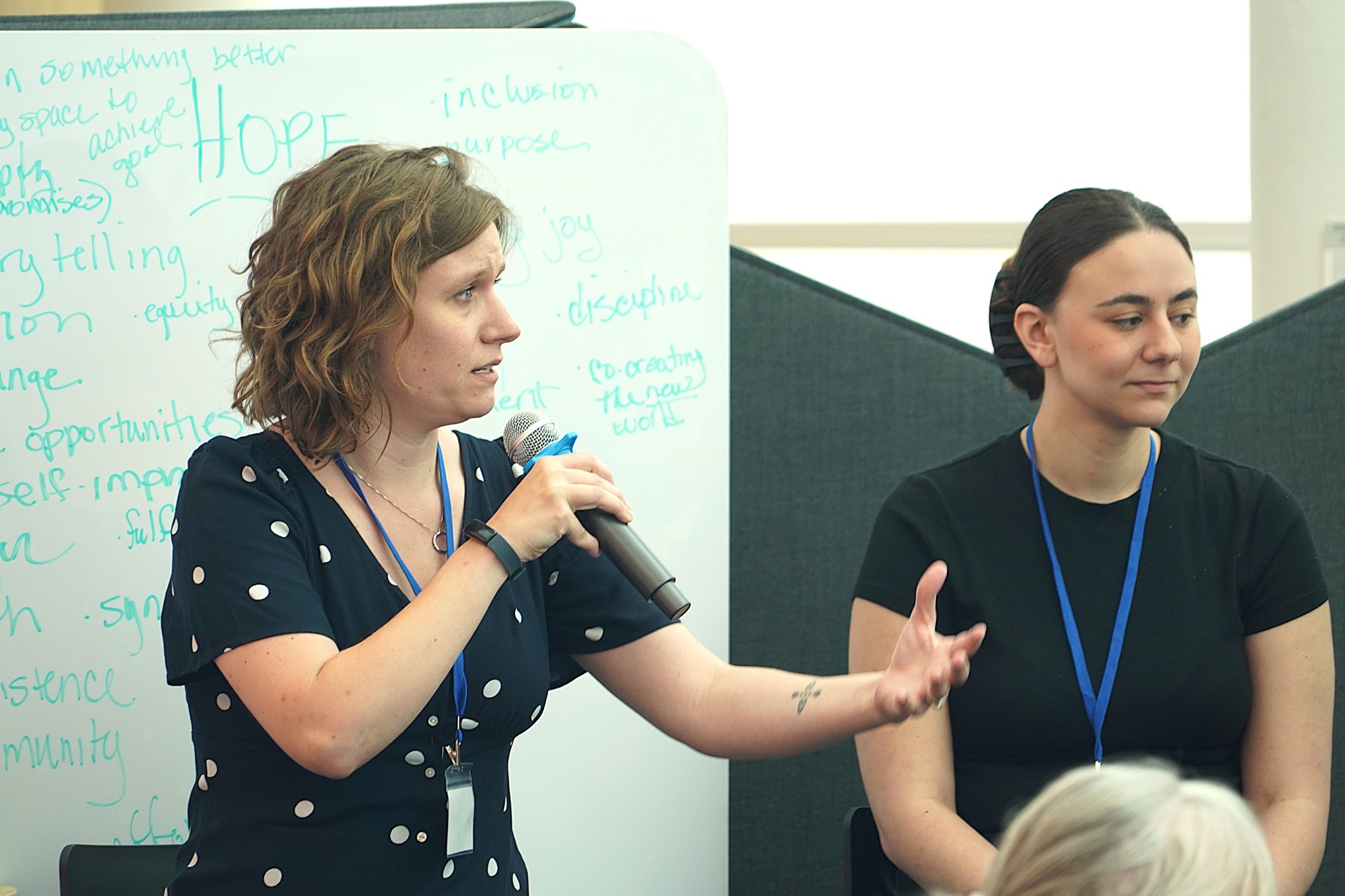 Woman with microphone gesturing